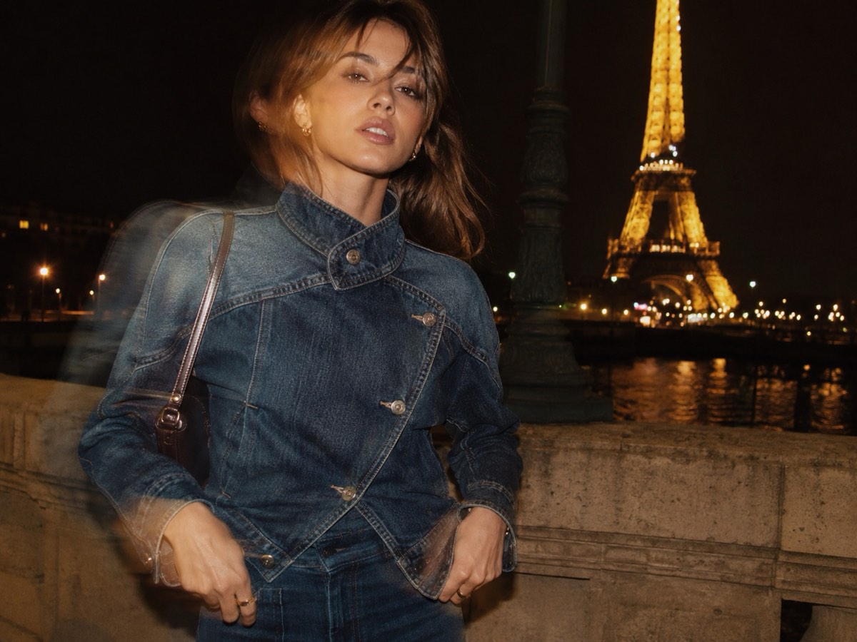 Dark-wash 90s denim jacket with a high collar, photographed at night by the river