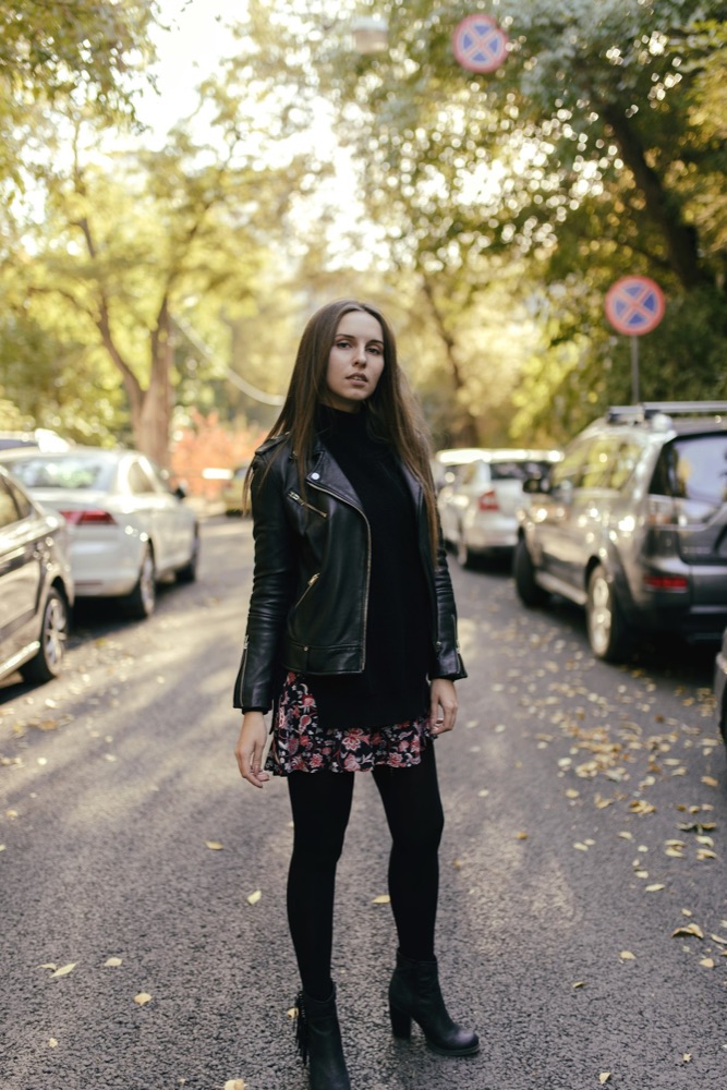 A street-style screenshot of a black leather biker jacket outfit